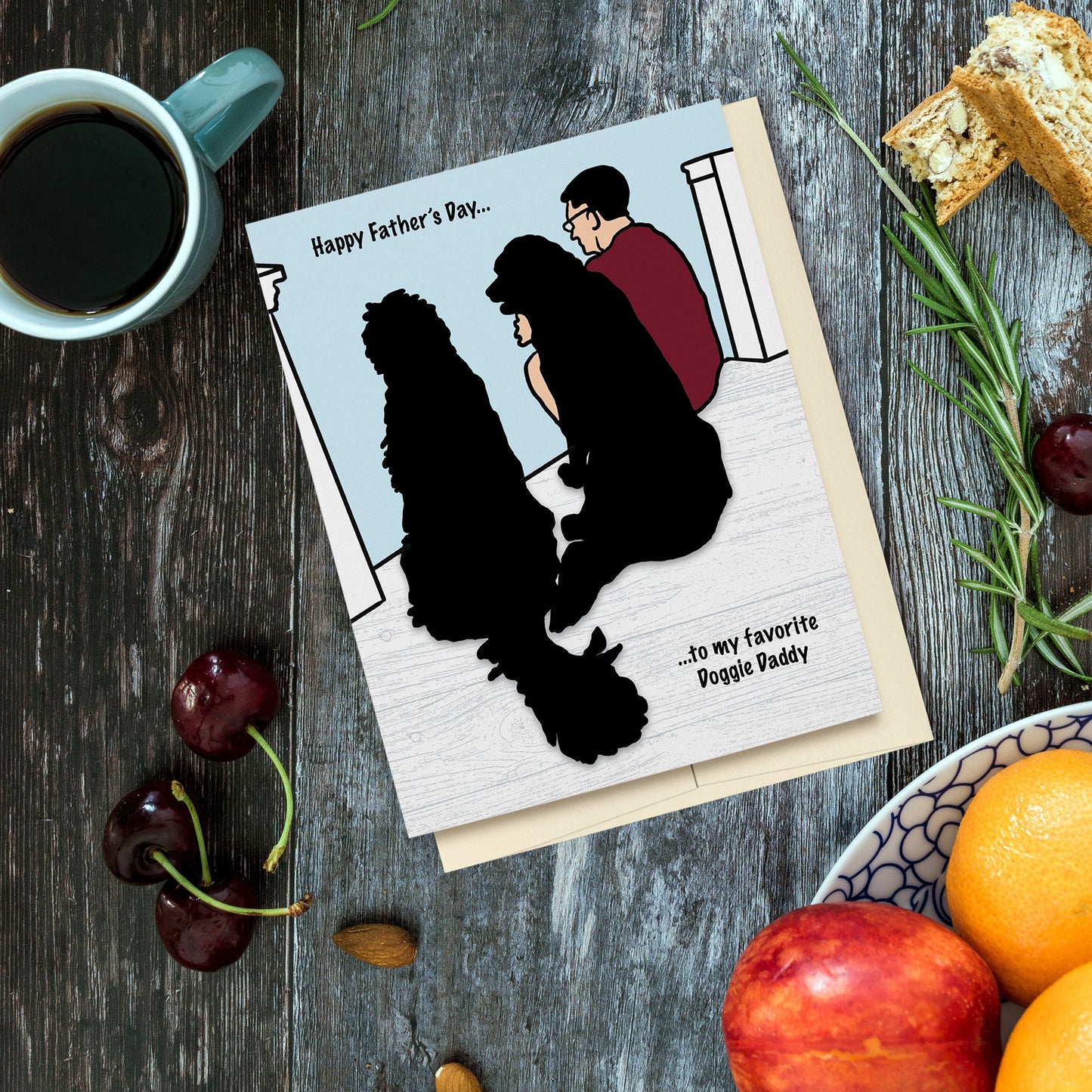 Happy Father's Day Doggie Daddy Card because doggie daddy's deserve some love too! Digitally hand drawn inspired by a photo of my husband and our two dogs. Reads, "Happy Father's Day to my favorite Doggie Daddy". Displayed on wood background surrounded by a cup of coffee, fruit, nuts, herbs and biscotti.