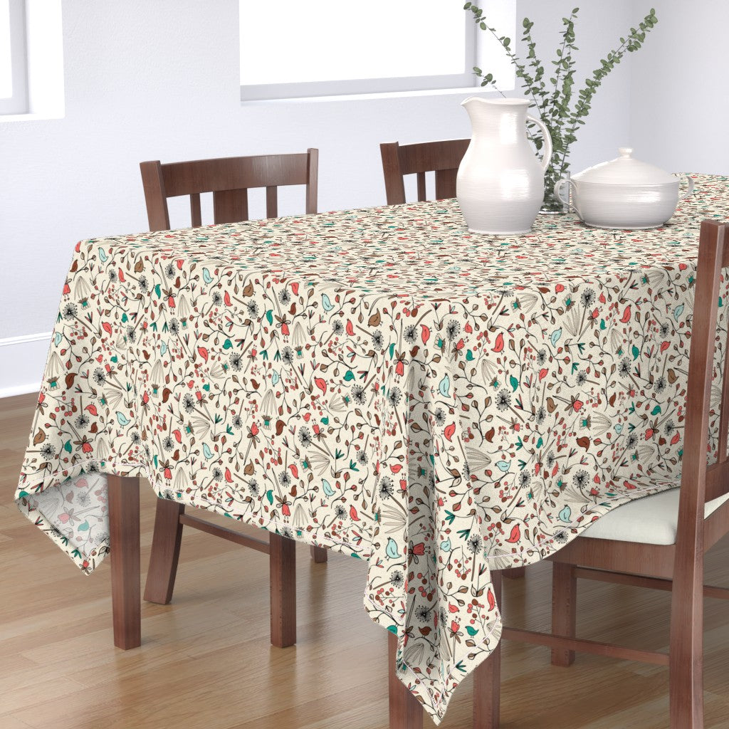 A table with a tablecloth adorning my cream-colored Flowers & Birds pattern design.