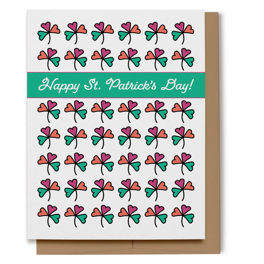 Happy St. Patrick's Day card with a pattern of colorful pink, green and orange shamrocks on a white background with a block of green with text which reads, "Happy St. Patrick's Day!". Digitally hand drawn.